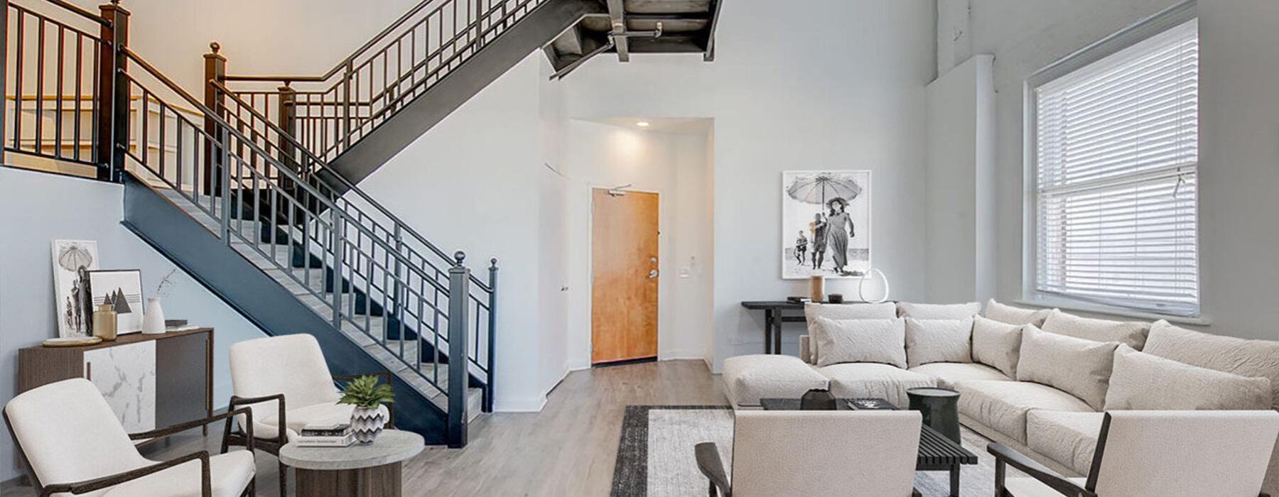 a room with a staircase and chairs